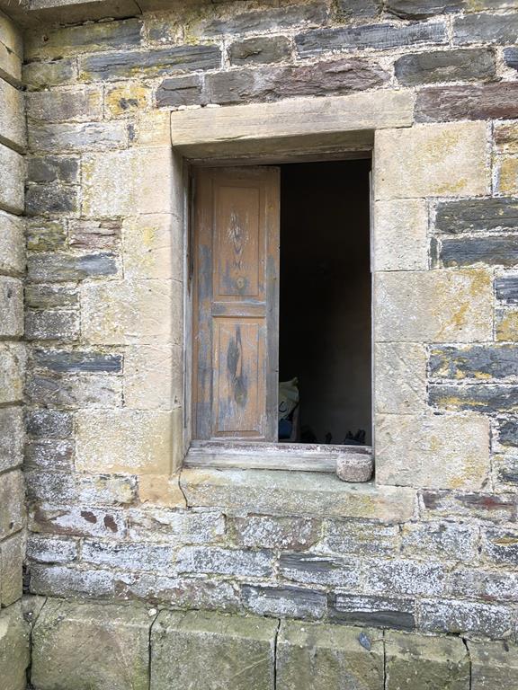 a half-shuttered window in the ruins of glassaugh house